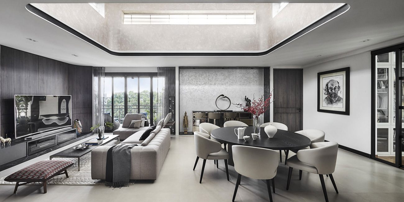 A modern living room with a skylight above the dining table.