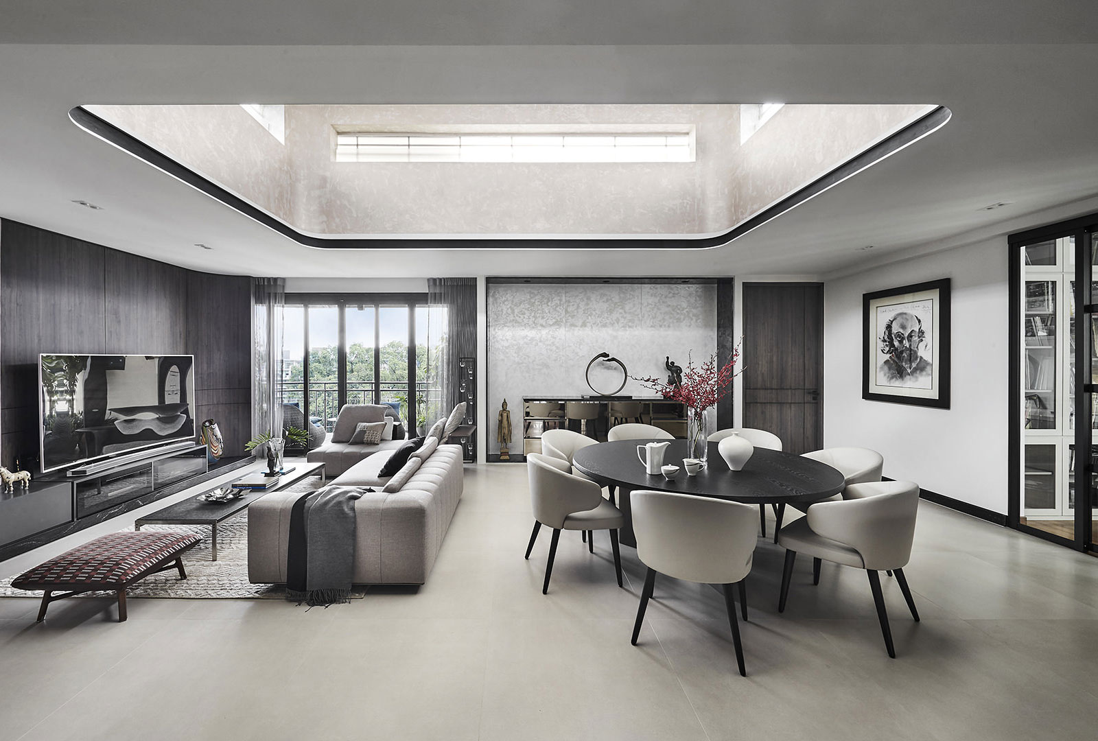 A modern living room with a skylight above the dining table.