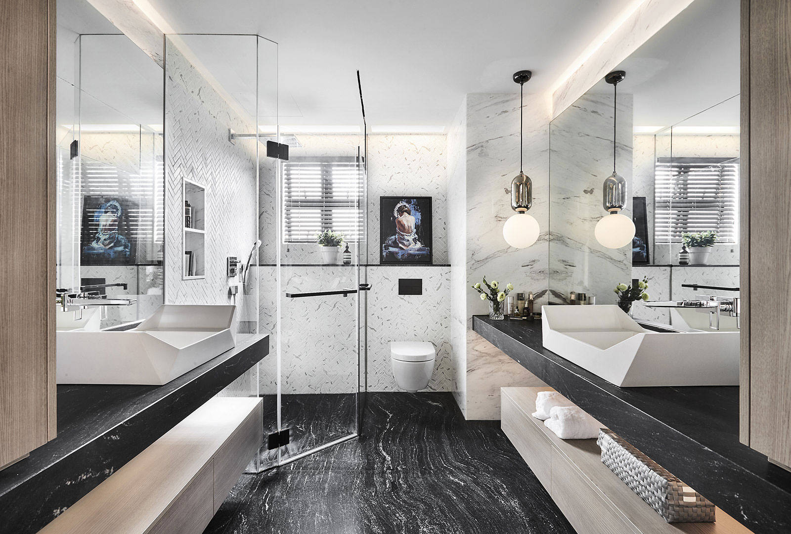 A modern bathroom with black and white marble floors.