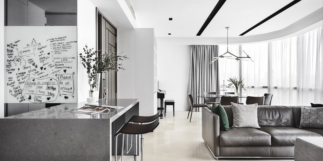 A black and white photo of a modern living room.