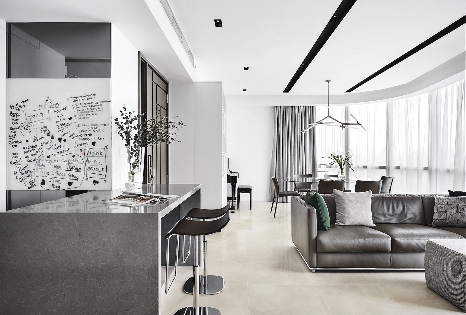 A black and white photo of a modern living room.