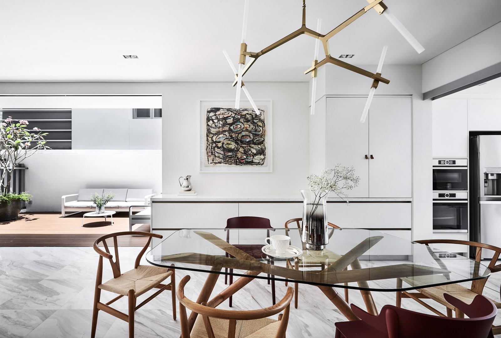 A dining room with a glass table and chairs.