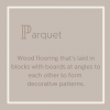 Parquet wood flooring that's laid in blocks with boards at angles to form decorations.