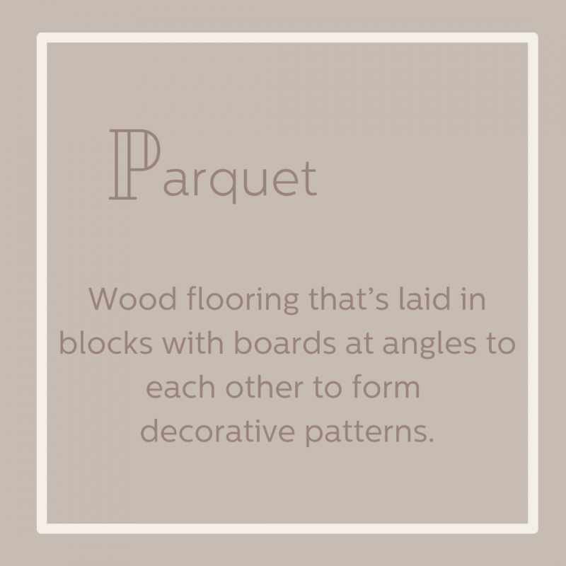 Parquet wood flooring that's laid in blocks with boards at angles to form decorations.