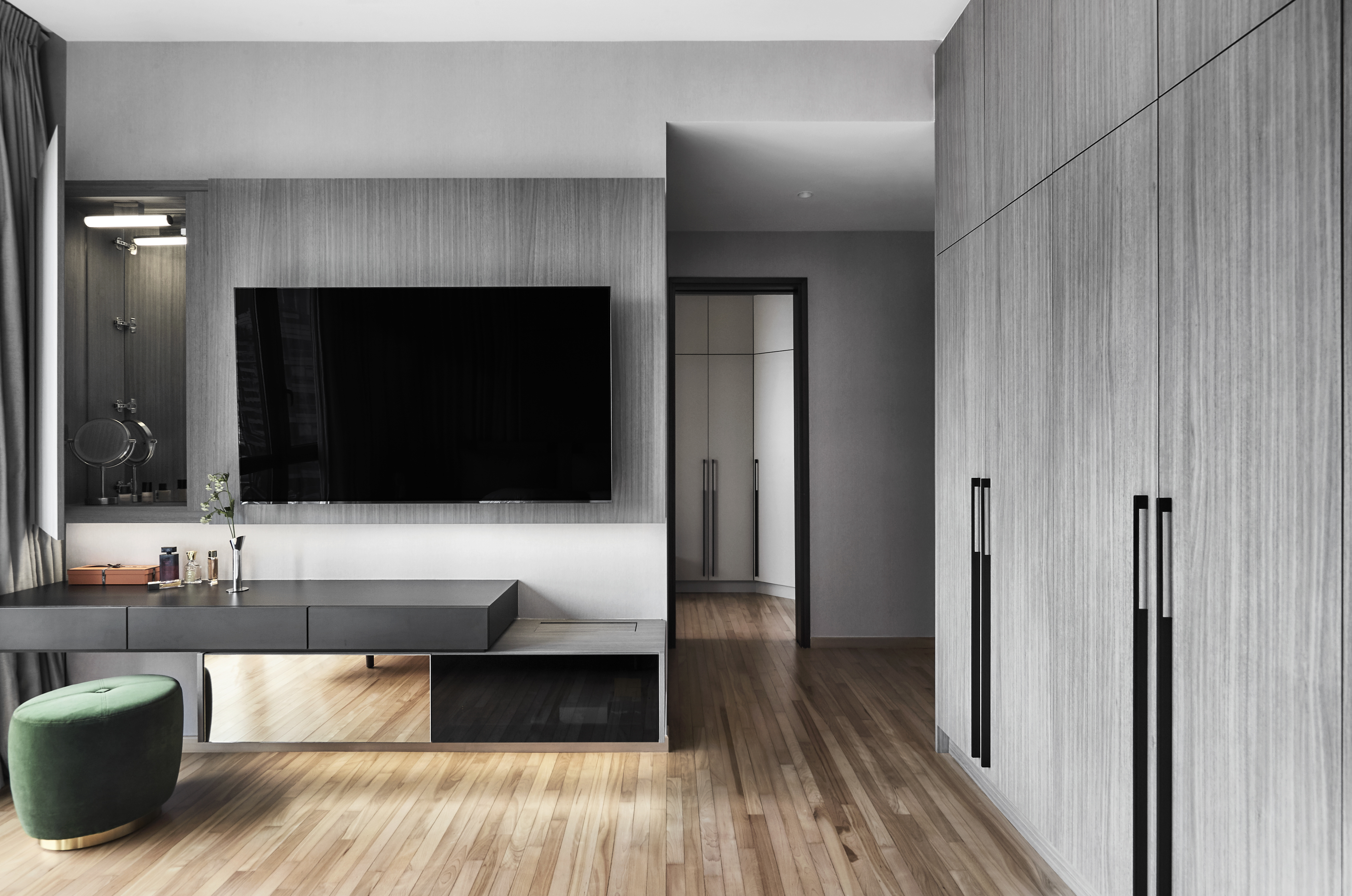 A modern bedroom with wooden cabinets and a tv.