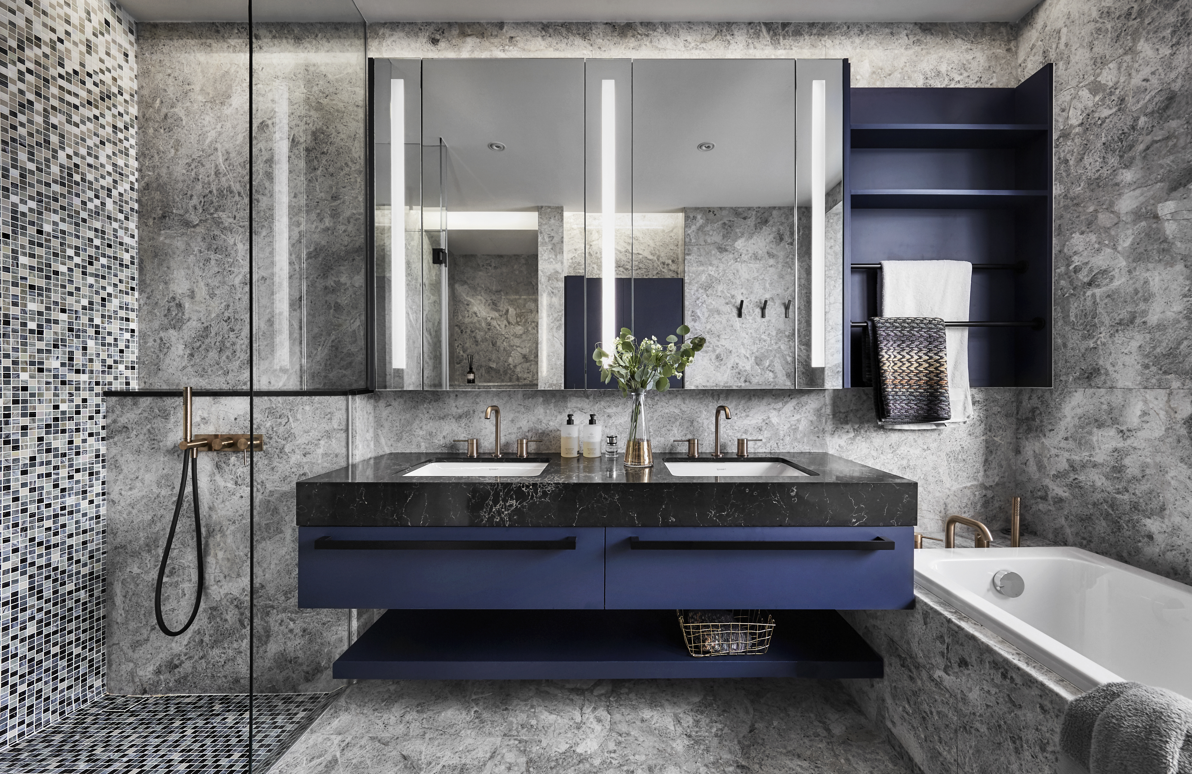 A modern bathroom with blue and black marble.