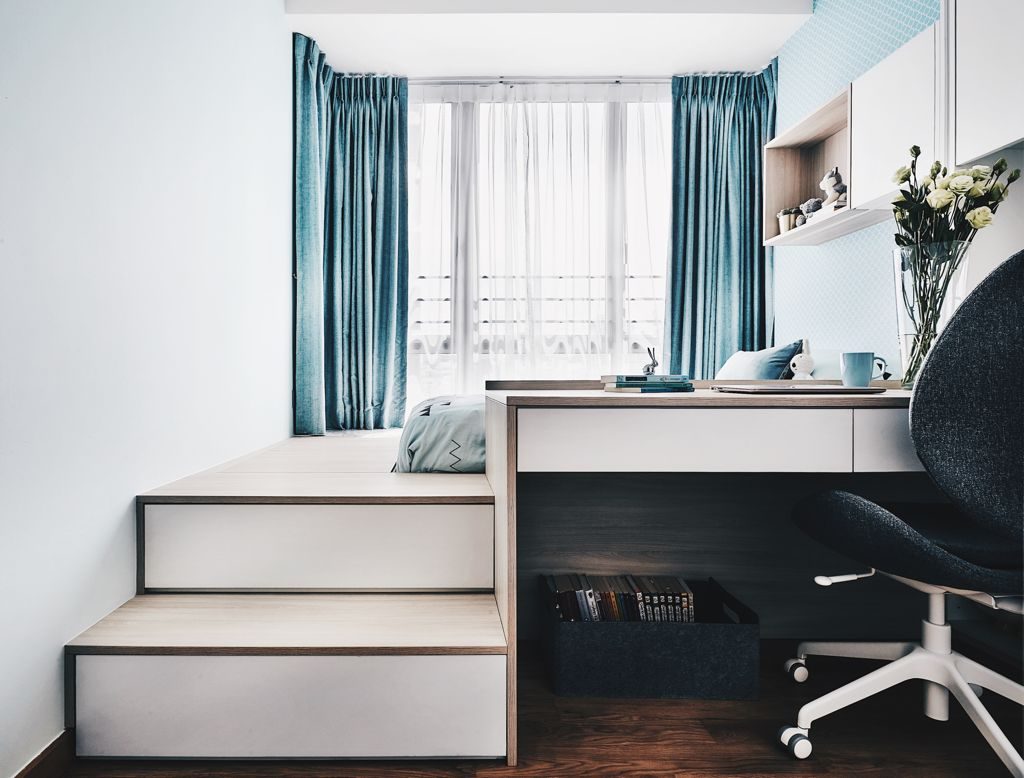 A small bedroom with a desk and chair.