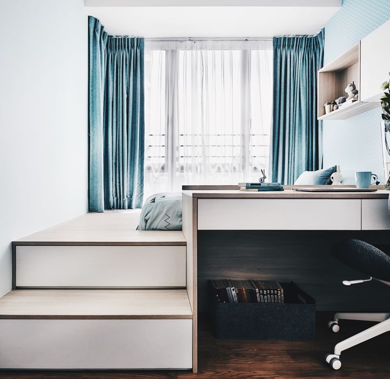 A small bedroom with a desk and chair.