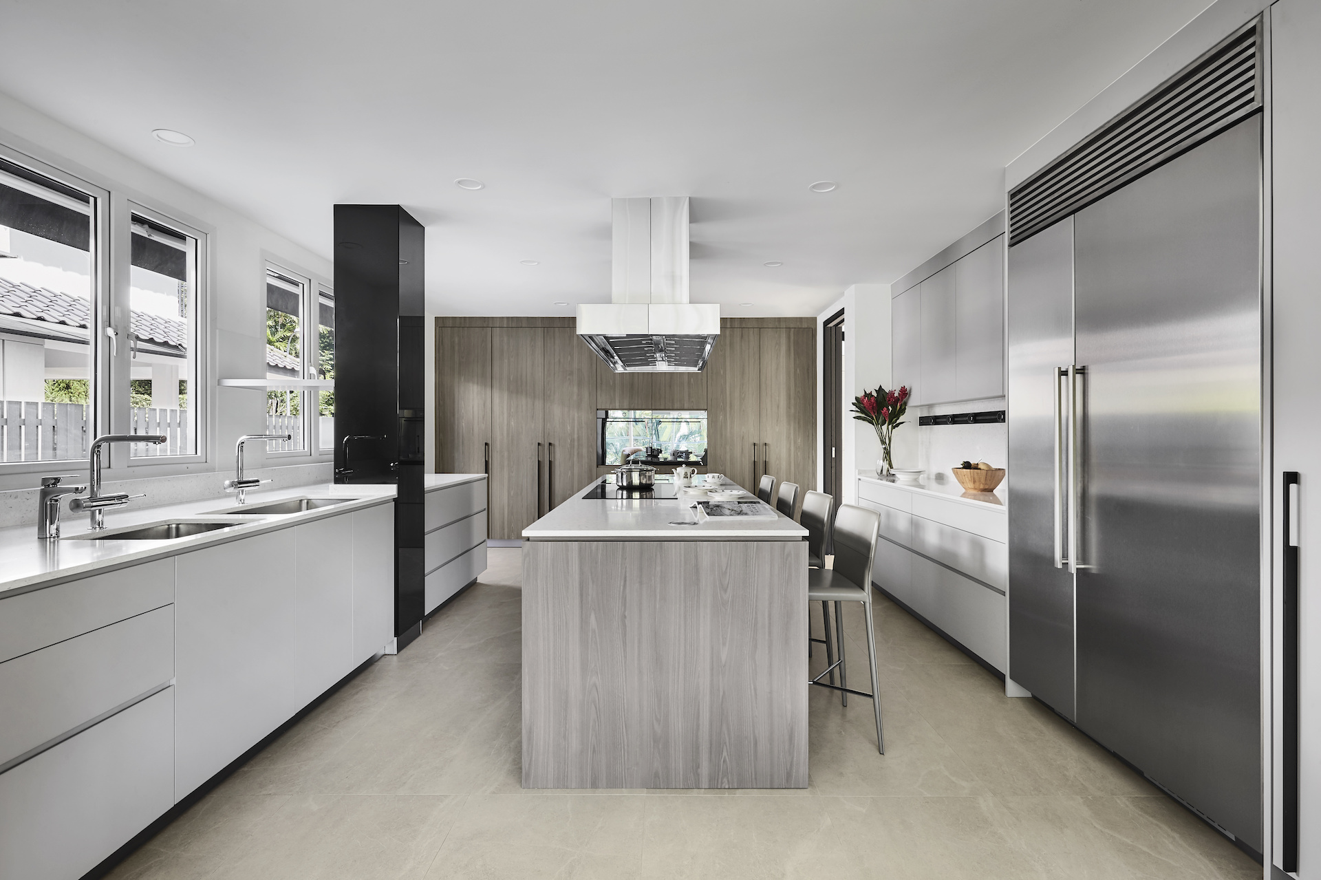 A modern kitchen with white cabinets and stainless steel appliances.