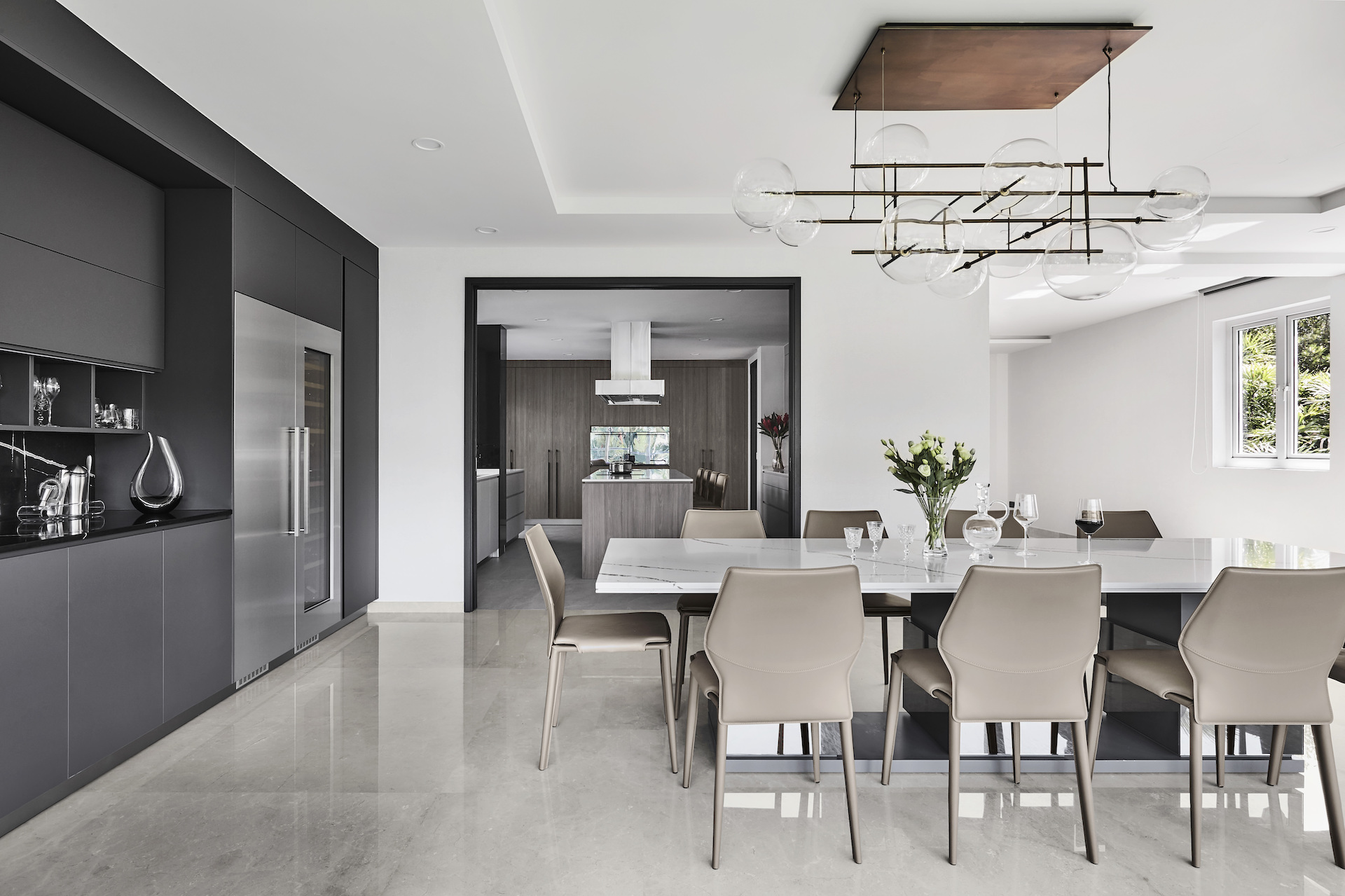A modern kitchen with a dining table and chairs.