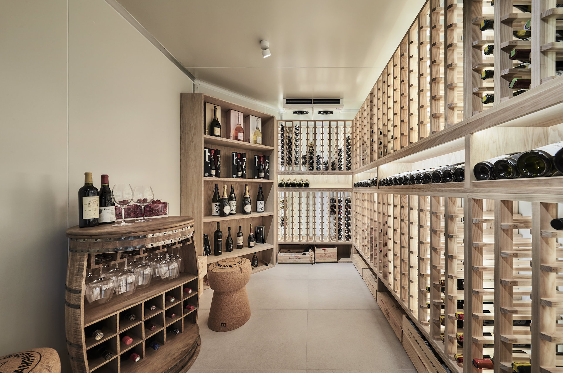 A wine cellar with wooden shelves and bottles.