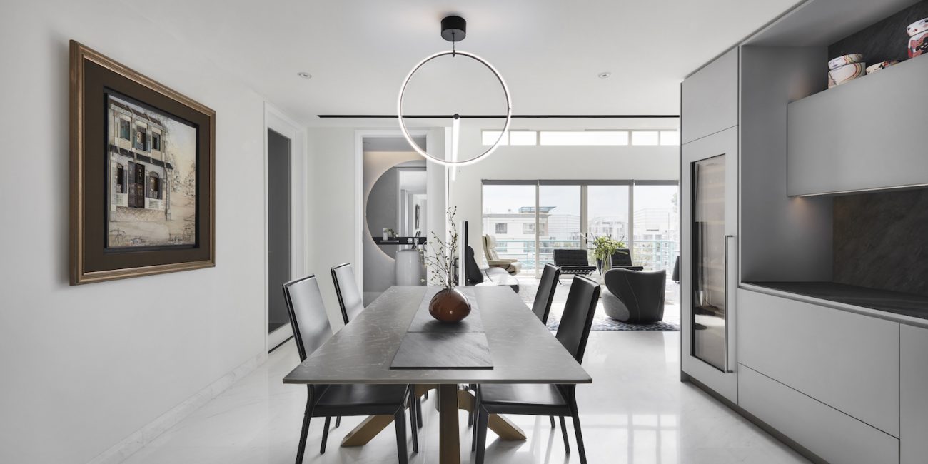 A modern kitchen with a dining table and chairs.