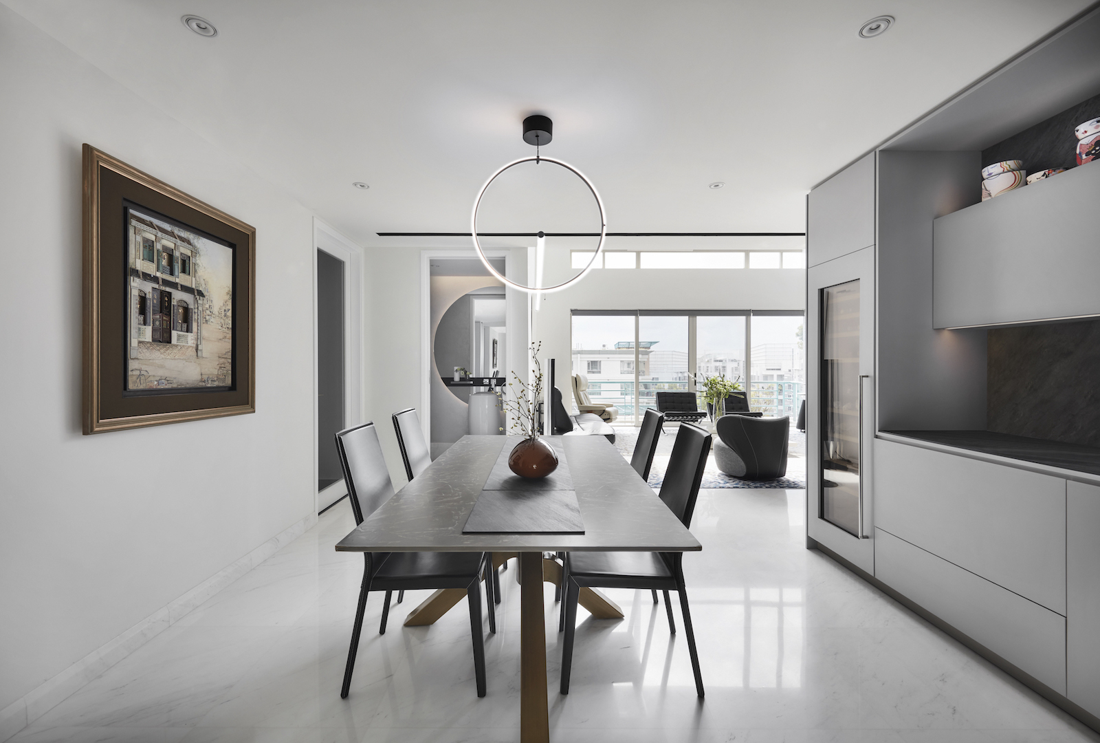 A modern kitchen with a dining table and chairs.