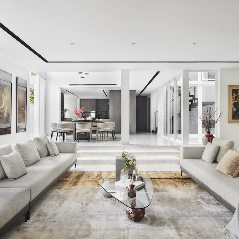 A modern living room with white walls and furniture.