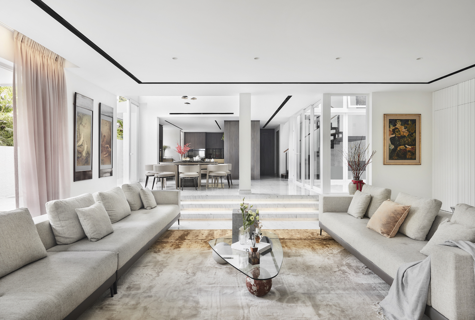 A modern living room with white walls and furniture.