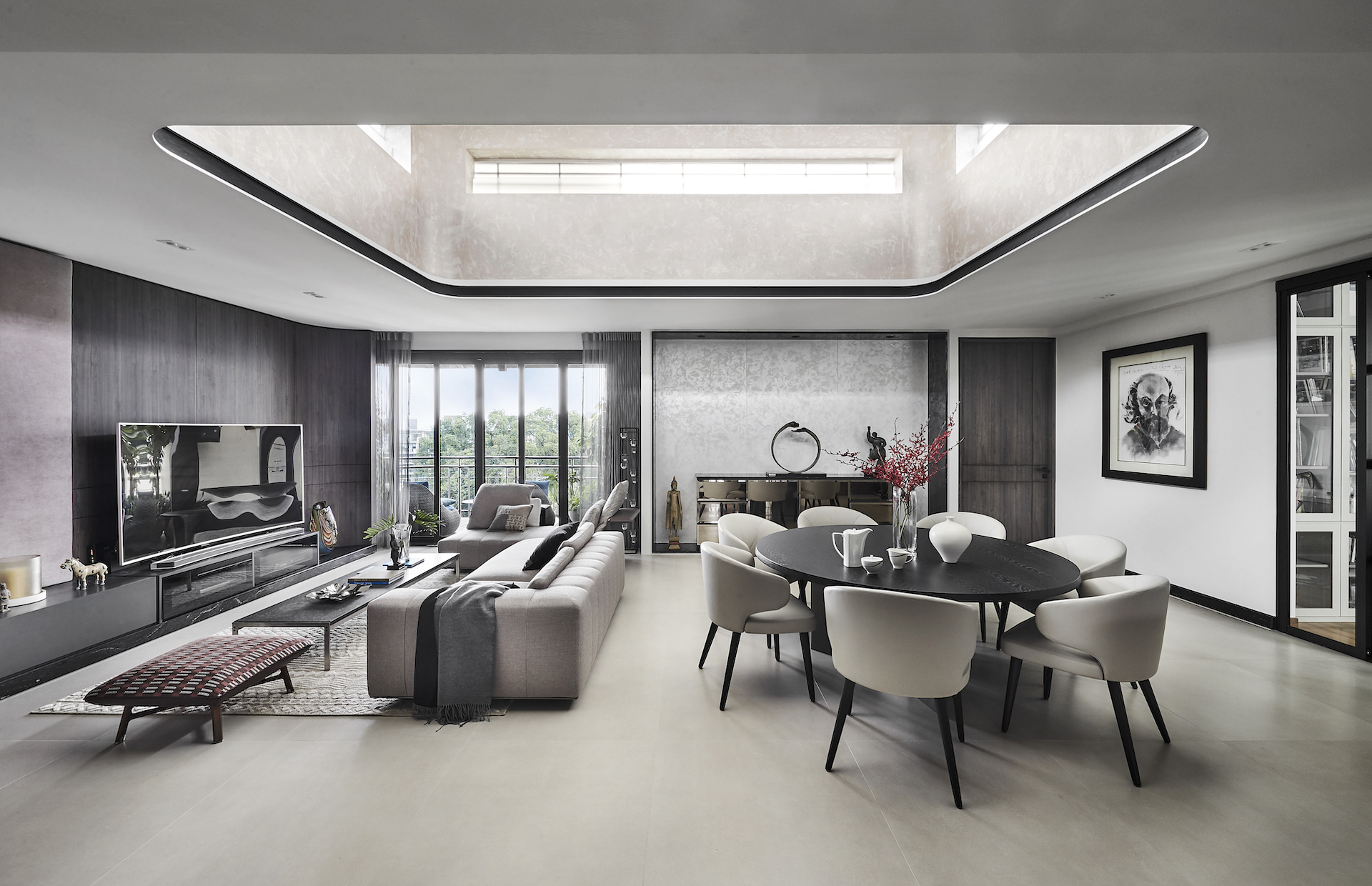 A modern living room with a skylight above the dining table.